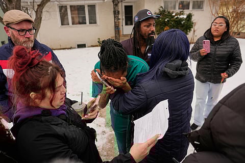 A family member, center, reacts after federal immigration officers make an arrest Sunday, January 11, 2026, in Minneapolis.