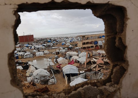 A photograph shows tent shelters housing displaced Palestinian families set up along the shore in Gaza City as strong winter winds sweep the Palestinian enclave on January 13, 2026.