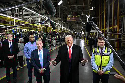 US President Donald Trump speaks alongside Ford executive chairman Bill Ford (3rd L), Ford CEO Jim farley, Treasury Secretary Scott Bessent (L) and plant manager Corey Williams as he tours Ford Motor Company's River Rouge complex in Dearborn, Michigan, on January 13, 2026.