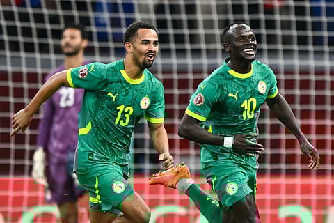 Senegal's forward #10 Sadio Mane celebrates his goal with Senegal's forward #13 Iliman Ndiaye during the Africa Cup of Nations (CAN) semi-final football match between Senegal and Egypt at the Grand stadium in Tangiers on January 14, 2026.