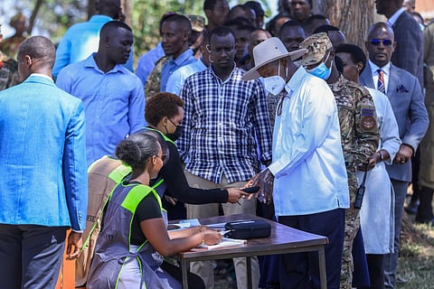 Officials from Uganda’s Electoral Commission checks the fingerprints of Uganda’s incumbent president and National Resistance Movement (NRM) presidential candidate Yoweri Museveni (3rd R) before he casts his ballot in Rwakitura on January 15, 2026 during Uganda’s 2026 general elections.