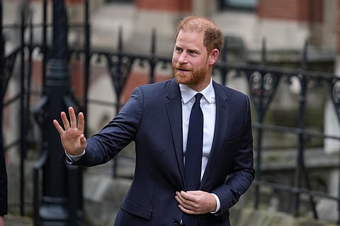 Britain's Prince Harry waves as he arrives at London's High Court to lead a group, including Elton John and Elizabeth Hurley, accusing the Daily Mail's publisher of privacy invasion through unlawful tactics in a trial that is part of a wider phone hacking scandal in London, Monday, Jan. 19, 2026.