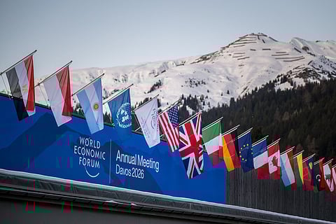 Graphic content / A sign of the World Economic Forum (WEF) is seen on the top of the Congress Centre that hosts the WEF annual meeting in the Alpine resort of Davos on its opening day in Davos on January 19, 2026.
