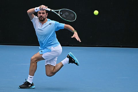 Switzerland’s Stan Wawrinka hits a return against Serbia’s Laslo Djere during their men's singles match on day two of the Australian Open tennis tournament in Melbourne on January 19, 2026.
