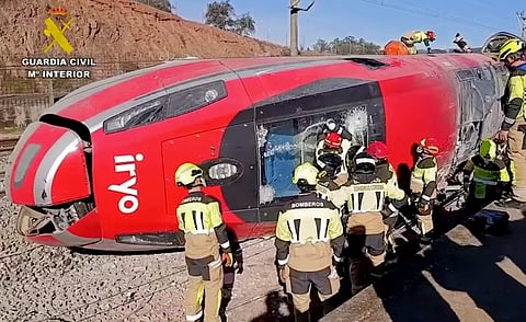 In this still image from video taken and released on January 19, 2026 by the Spain's Guardia Civil, emergency workers are seen at the site where a high-speed Iryo train derailed and was hit by another train as rescue efforts continue in Adamuz, southern Spain, on January 19, 2026.