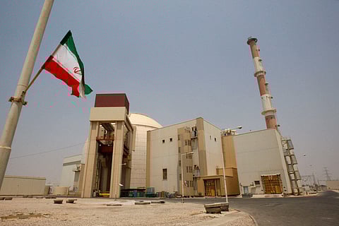 FILE - An Iranian flag flutters in front of the reactor building of the Bushehr nuclear power plant, just outside the southern city of Bushehr, Iran, Aug. 21, 2010. (AP Photo/Vahid Salemi, File)