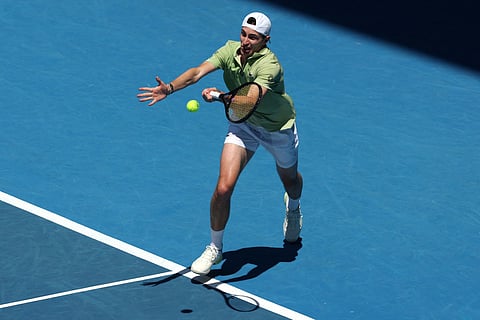 France's Ugo Humbert hits a return to USA's Ben Shelton during their men's singles match on day three of the Australian Open tennis tournament in Melbourne on January 20, 2026.