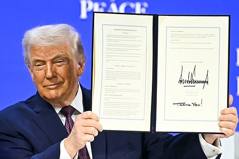 US President Donald Trump holds a signed founding charter at the "Board of Peace" meeting during the World Economic Forum (WEF) annual meeting in Davos on January 22, 2026.