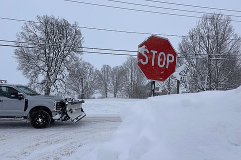 A driver navigates fresh snowfall in Lowville, New York, on Friday, Jan. 23, 2026. (AP Photo/Cara Anna)