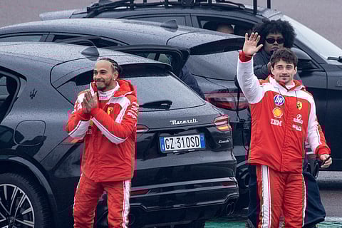 Ferrari's British driver Lewis Hamilton (L) and Ferrari's Monegasque driver Charles Leclerc wave to fans after testing the new Formula 1 Ferrari SF-26 at Fiorano Circuit in Fiorano Modenese.