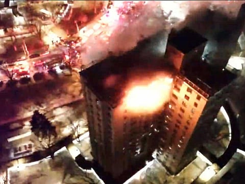 FDNY members operating at a fire on the top two floors of a high-rise apartment in the Bronx, New York City.