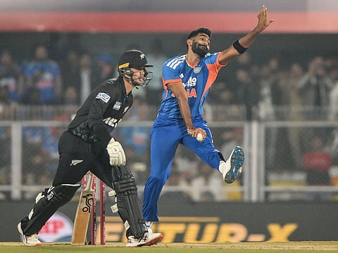 India's Jasprit Bumrah (R) bowls during the third T20I against New Zealand at the Barsapara Cricket Stadium in Guwahati on January 25, 2026.