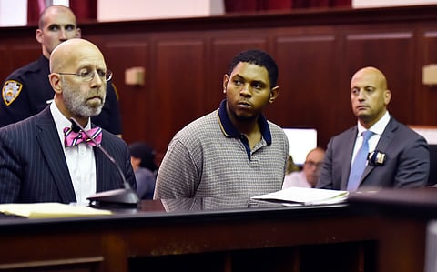 FILE - Randy Santos, center, is arraigned in criminal court for the murder of four homeless men, Oct. 6, 2019, in New York.