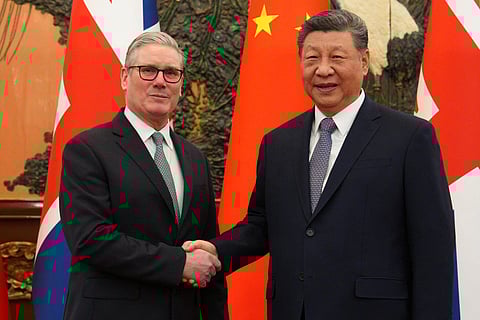 China's President Xi Jinping (R) and Britain's Prime Minister Keir Starmer shake hands before their meeting at the Great Hall of the People in Beijing on January 29, 2026.