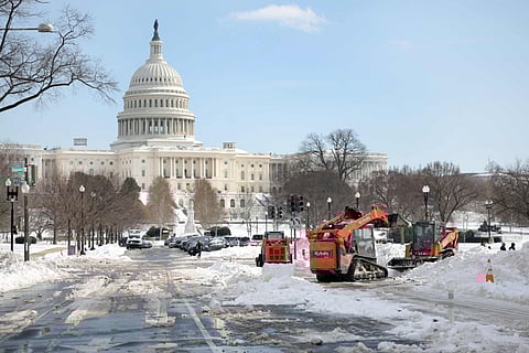 Crews work to clear snow on Pennsylvania Avenue near the US Capitol on January 28, 2026 in Washington, DC. Residents in Washington, DC are growing fustrated as many roads and sidewalks remain covered in snow and public schools remain closed for a third day.