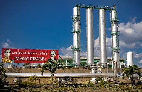 A billboard with images of Cuban national hero Jose Marti (R) and Venezuelan Simon Bolivar is seen at the entrance of the Cienfuegos oil refinery, 250 km southeast of Havana, on February 11, 2013.