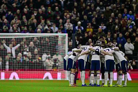 Spurs players huddle at the start of their Premier League match against Manchester City