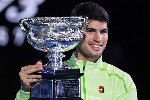 Spain's Carlos Alcaraz celebrates with the Norman Brookes Challenge Cup after winning the men's singles final match against Serbia's Novak Djokovic on day fifteen of the Australian Open tennis tournament in Melbourne on February 1, 2026.