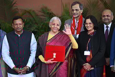 India's Finance Minister Nirmala Sitharaman (C) poses for photos before she leaves the Finance Ministry to present the annual budget to parliament at the Kartavya Bhavan in New Delhi on February 1, 2026.