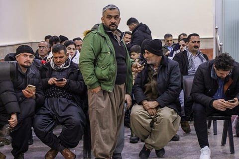 Mainly Iranian Kurds wait at the Haji Omran border crossing terminal with Iran, in Iraq's autonomous northern Kurdish region, on February 1, 2026, which is open to travellers and economic trade.
