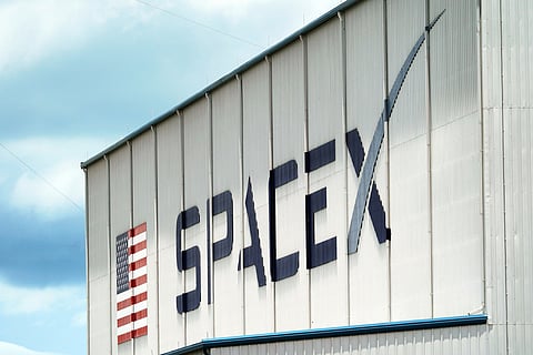 FILE - A SpaceX logo is displayed on a building, May 26, 2020, at the Kennedy Space Center in Cape Canaveral, Fla. (AP Photo/David J. Phillip, File)