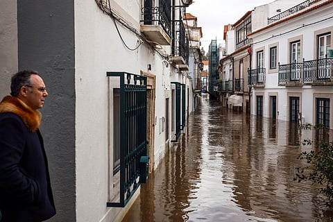 A man observes the flooded streets of Alcacer do Sal, south of Portugal, amid Storm Leonardo on February 5, 2026.