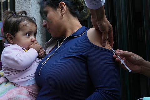 A health worker administers a dose of the measles vaccine outside a public hospital in Mexico City, Wednesday, Feb. 4, 2026. (AP Photo/Marco Ugarte)