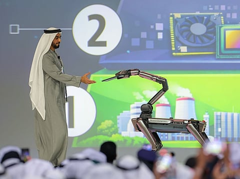 Sheikh Saif bin Zayed receives the chip from a robot at WGS on Thursday
