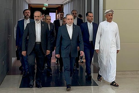In this handout photo obtained from Iran’s foreign ministry delegation on February 6, 2026, Iran’s Foreign Minister Abbas Araghchi (C) arrives for a meeting in Muscat.