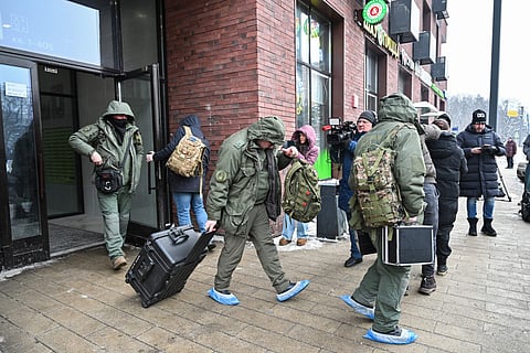 Investigators leave a high-rise residential building, the scene of an assassination attempt on Russian Lieutenant General Vladimir Alekseyev, in Moscow on February 6, 2026.