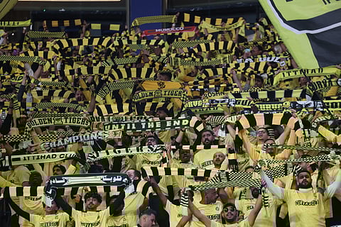 Al Ittihad's supporters cheer for their team during a Saudi Pro League football match against Al-Nassr at Al-Awwal Park Stadium, in Riyadh on February 6, 2026.