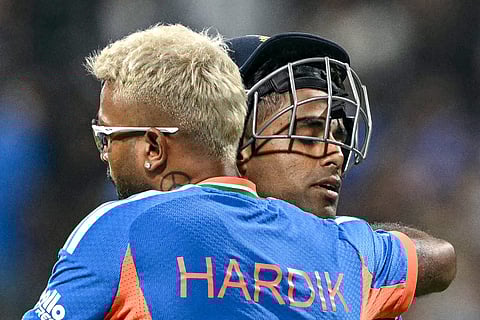 India's captain Suryakumar Yadav (R) is being hugged by his teammate Hardik Pandya at the end of Indian inning during the 2026 ICC Men's T20 Cricket World Cup group stage match between India and USA at the Wankhede Stadium in Mumbai on February 7, 2026.