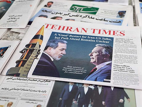 A photograph shows copies of Iranian daily newspapers reporting on the first round of talks between Iran and the United States at a kiosk in Tehran on February 7, 2026.