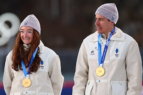 Gold medallists pose with their medals on the podium during the Milano Cortina 2026 Winter Olympic Games on February 8, 2026.