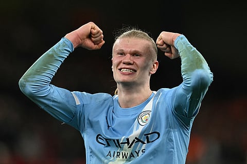 Erling Haaland celebrates his team's victory at Anfield