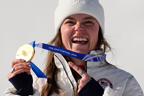 United States' Breezy Johnson shows her gold medal before it breaks