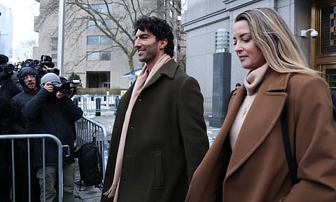 US actor and director Justin Baldoni leaves federal court holding hands with his wife Emily Baldoni following a court-ordered settlement conference in his ongoing legal dispute with actress Blake Lively related to the film "It Ends With Us," in New York on February 11, 2026.