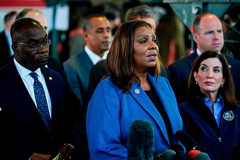 FILE - New York Attorney General Letitia James, center, flanked by Buffalo Mayor Byron Brown, left, and New York Gov. Kathy Hochul, speaks with members of the media during a news conference near the scene of a shooting at a supermarket, in Buffalo, N.Y., May 15, 2022.