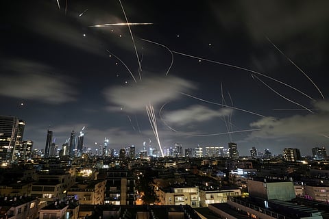 FILE - The Israeli Iron Dome air defense system intercepts missiles during an Iranian attack on Tel Aviv, Israel, June 18, 2025. (AP Photo/Leo Correa, File)