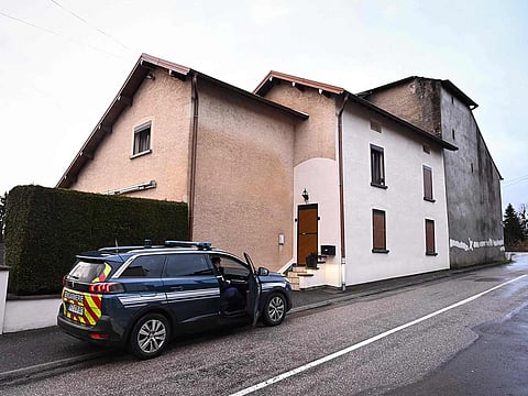 French Gendarmes gather outside the house where the bodies of two infants have been discovered in a freezer in Ailleviller-et-Lyaumont, eastern France on February 12, 2026.