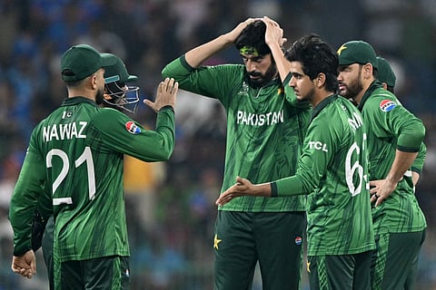 Pakistan's Saim Ayub (R) celebrates with teammates after taking the wicket of India's Tilak Varma during the 2026 ICC Men's T20 Cricket World Cup group stage match between India and Pakistan at the R Premadasa Stadium in Colombo on February 15, 2026.