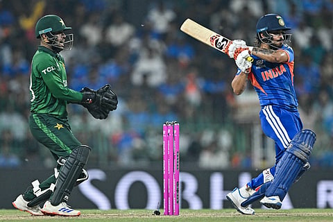 India's Ishan Kishan (R) plays a shot as Pakistan's wicketkeeper Usman Khan reacts during the 2026 ICC Men's T20 Cricket World Cup group stage match between India and Pakistan at the R Premadasa Stadium in Colombo on February 15, 2026.