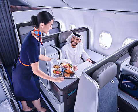 A flydubai cabin crew serves a passenger onboard its Business Class cabin. The carrier confirmed it will begin twice-daily services to Bangkok from September, expanding its footprint in Southeast Asia.