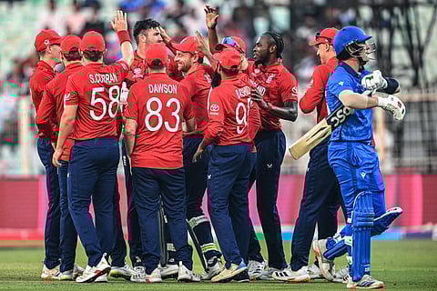 England's players celebrate after the dismissal of Italy's captain Harry Manenti (R) during the 2026 ICC Men's T20 Cricket World Cup group stage match between England and Italy at the Eden Gardens in Kolkata on February 16, 2026.
