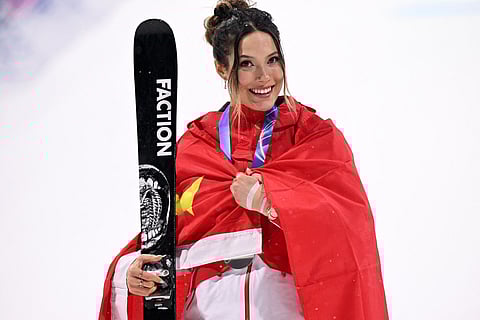 Silver medallist China's Eileen Gu celebrates on the podium after the freestyle skiing women's freeski big air final during the Milano Cortina 2026 Winter Olympic Games 2026.