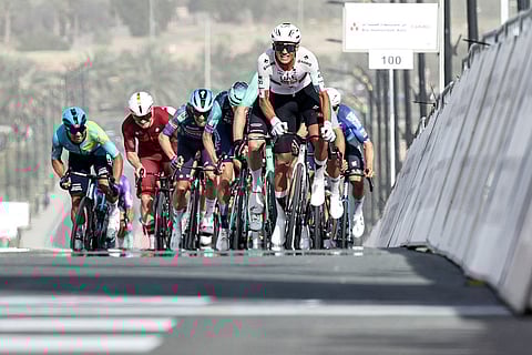 UAE Team Emirates's Mexican rider Isaac Del Toro Romero leads the pack while approaching the finish line during the first stage of the UAE Tour cycling event from Madinat Zayed Majlis to Liwa Palace in Abu Dhabi on February 16, 2026.