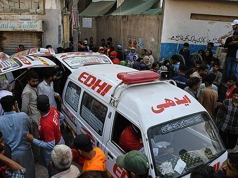Rescue workers help in the operations following a gas explosion at an apartment building, in Karachi, Pakistan, Thursday, Feb. 19, 2026.