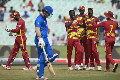 West Indies' players celebrate after the dismissal of Italy's captain Harry Manenti during the 2026 ICC Men's T20 Cricket World Cup group stage match between West Indies and Italy at the Eden Gardens in Kolkata on February 19, 2026.