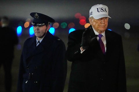President Donald Trump waves after stepping off Air Force One, Thursday, Feb. 19, 2026, at Joint Base Andrews, Md., on return from a trip to Georgia.