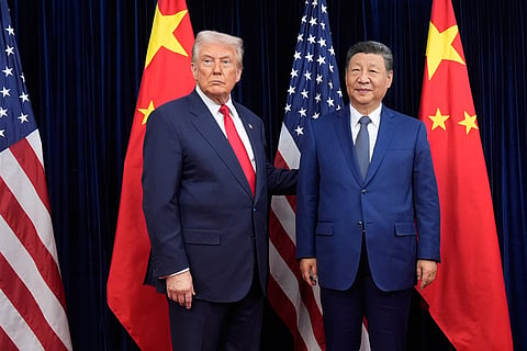 President Donald Trump, left, and Chinese President Xi Jinping pose ahead of their summit talk at Gimhae International Airport in Busan, South Korea, October 30, 2025. Trump is scheduled to meet Xi in Beijing on May 14-15.